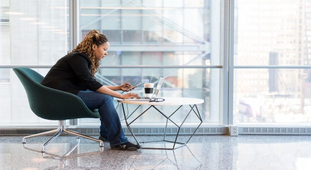 Woman sitting on a chair in a office and working on a laptop